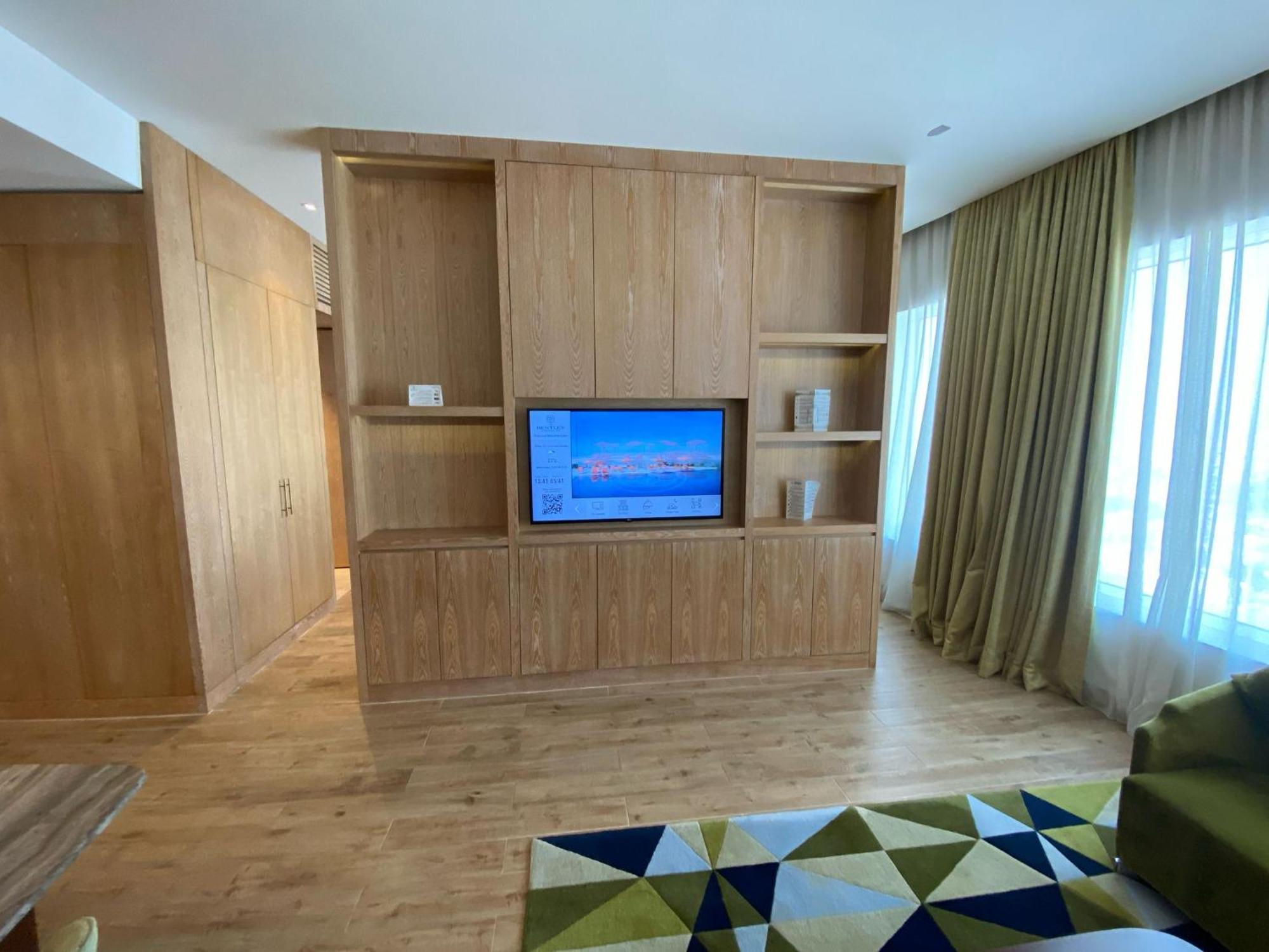 The Bentley Luxury Hotel & Suites Doha Bagian luar foto A television in a hotel room